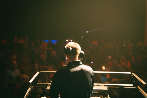 Corporate DJ facing crowd as he mixes