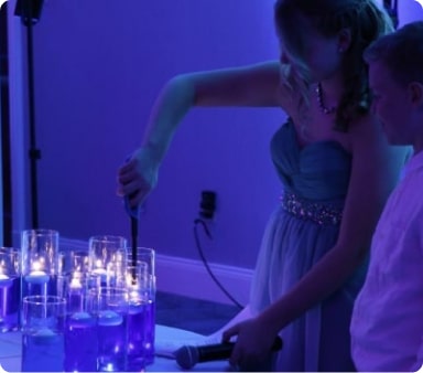 A young girl lighting the candle for the ceremony