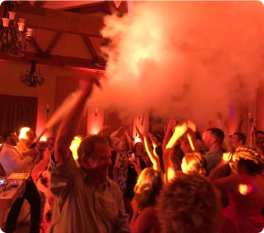 Group partying in red lights with a CO2 cannon going off