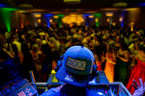 Klock Hat facing the camera as the DJ looks out into the crowd of students